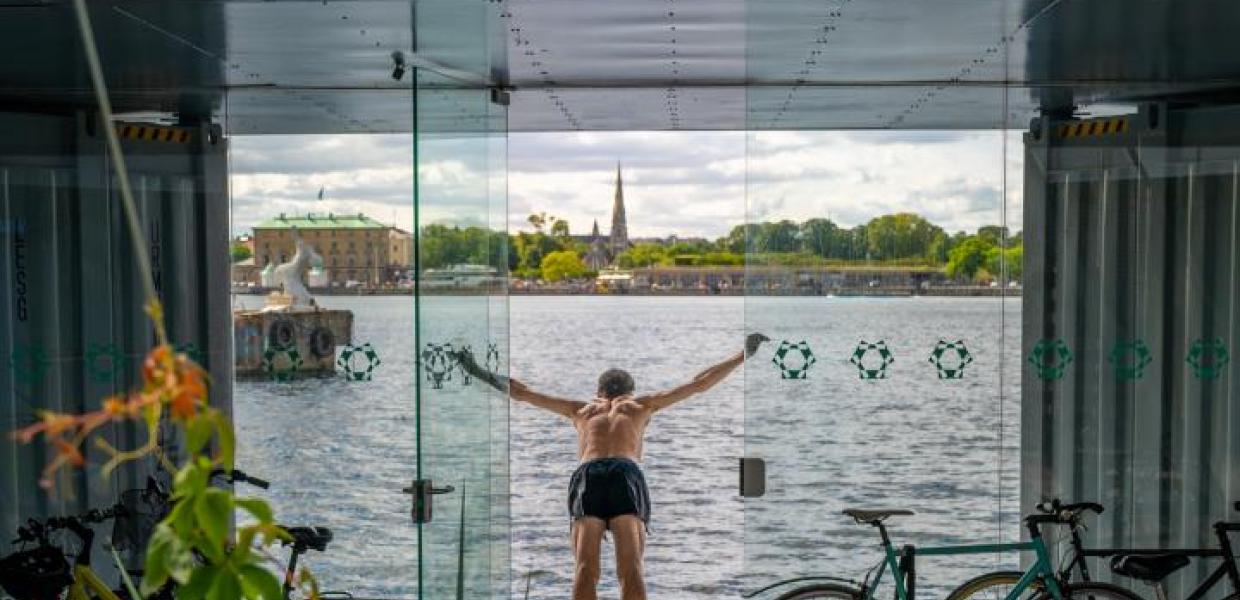 A man swims from the Urban Rigger student housing block designed by Bjarke Ingels Group in Copenhagen, Denmark