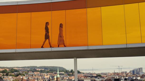 Two people walking in Your rainbow panorama, ARoS Aarhus Art Museum