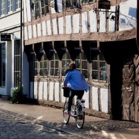 Cycling down an old street in Odense, Denmark