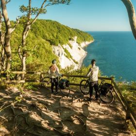 A couple with their bikes, exploring the coastland near Møns Klint